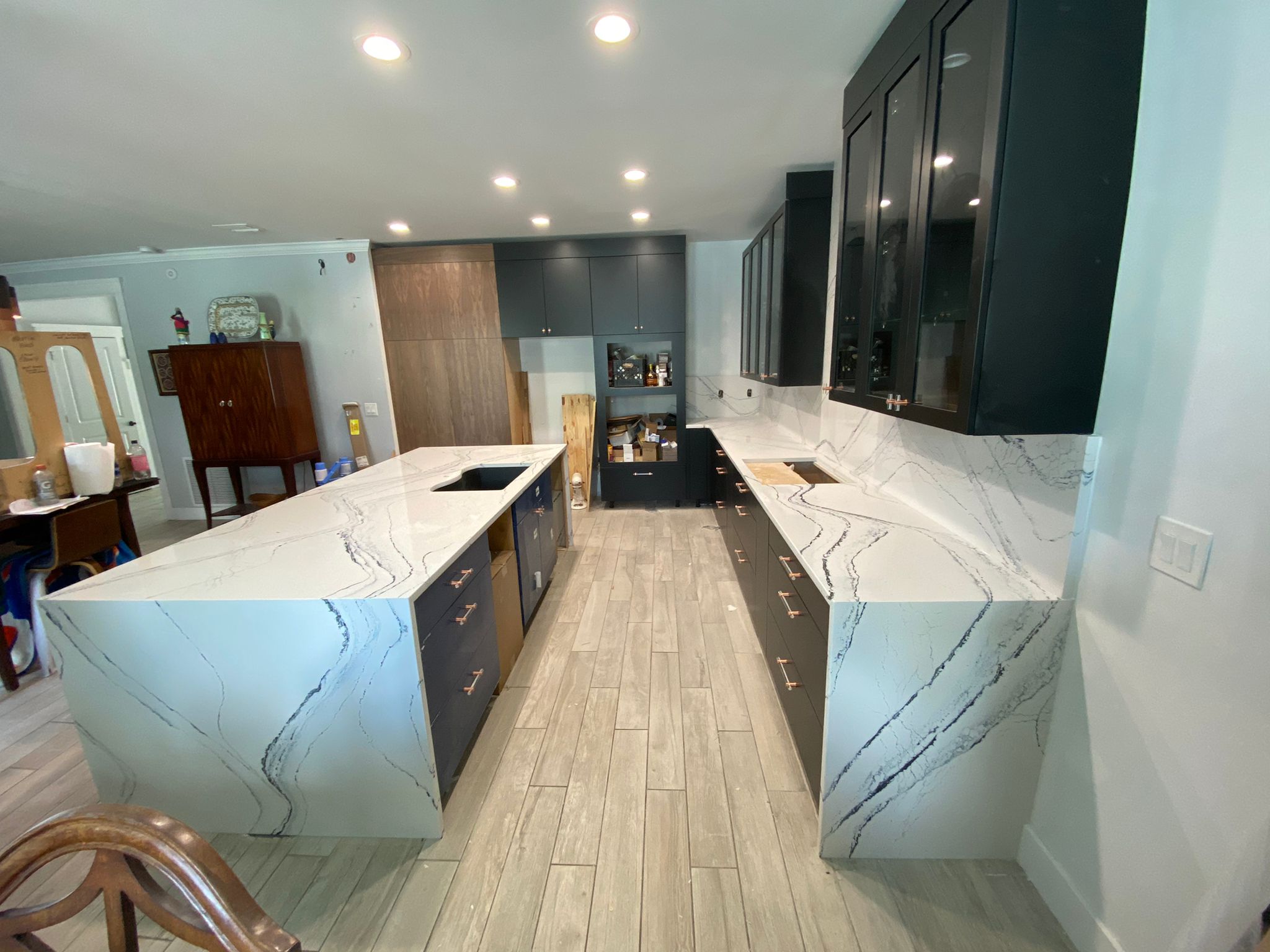 Luxury kitchen with dark cabinets and white marble countertops